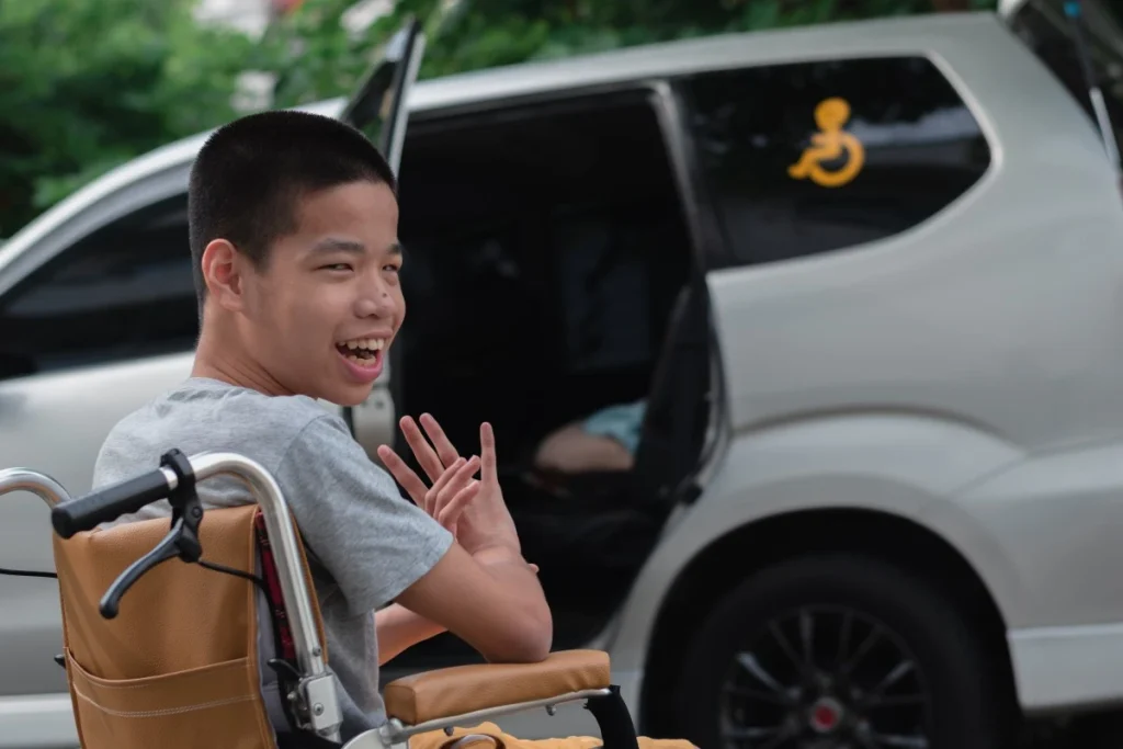 Disabled boy in his wheelchair smiling