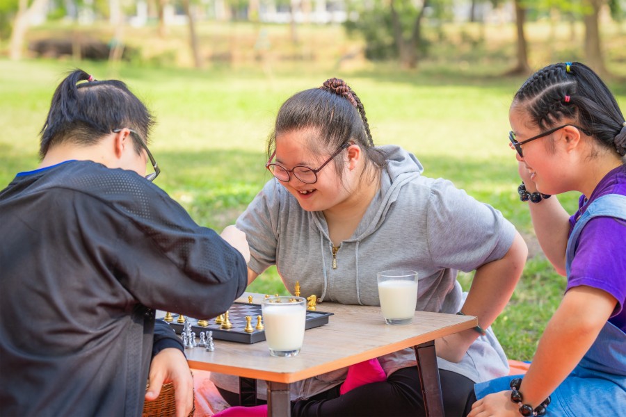 Disabled group of friends playing chess outside